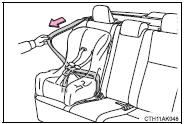 4 While pushing the child restraint system into the rear seat, allow the shoulder