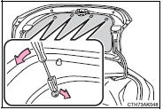 2 Partly remove the trunk panel cover and turn the bulb base counterclockwise.