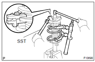 Toyota Corolla.  Remove shock absorber assy front lh