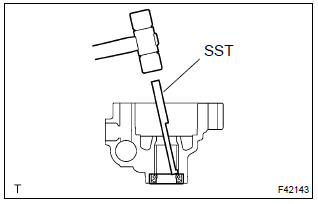 Toyota Corolla. Remove vane pump housing oil seal