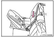 4 While pushing the child restraint system down into the rear seat, allow the