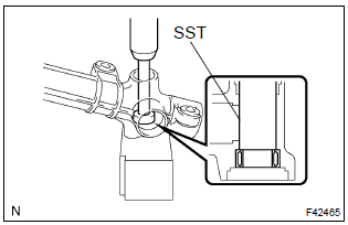 Toyota Corolla.  Remove power steering control valve lower bearing